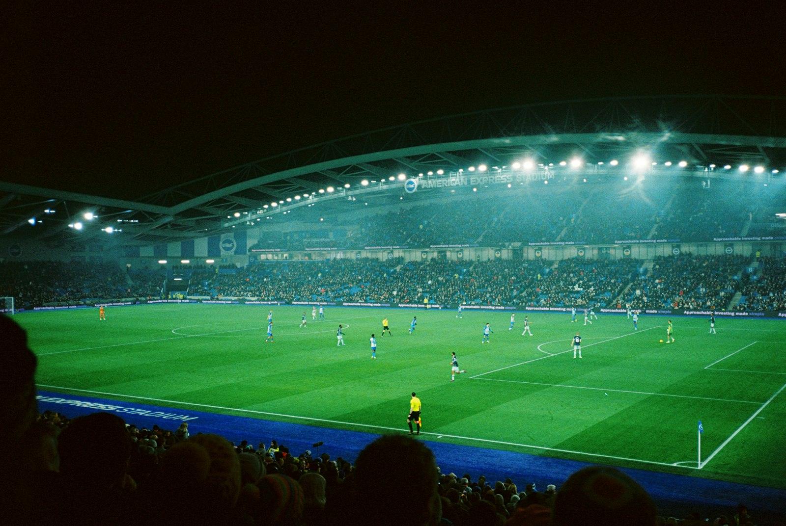 A floodlit football stadium at night
